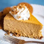 a slice of creamy pumpkin cheesecake on a plate