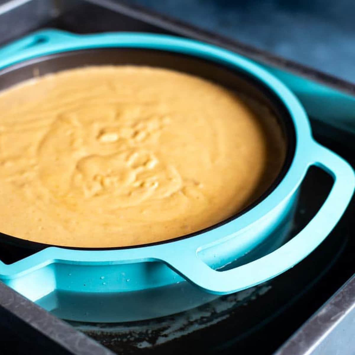 unbaked pumpkin cheesecake in a water bath