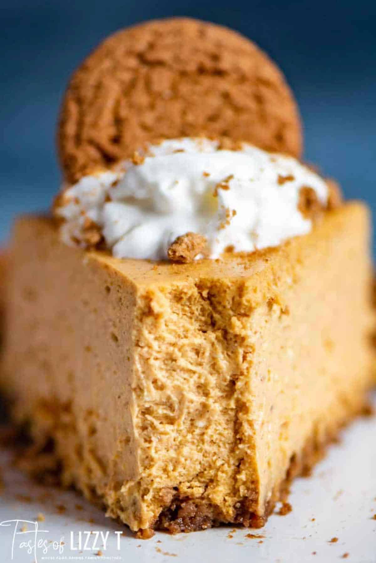 a piece of olive garden pumpkin cheesecake on a plate with one bite out