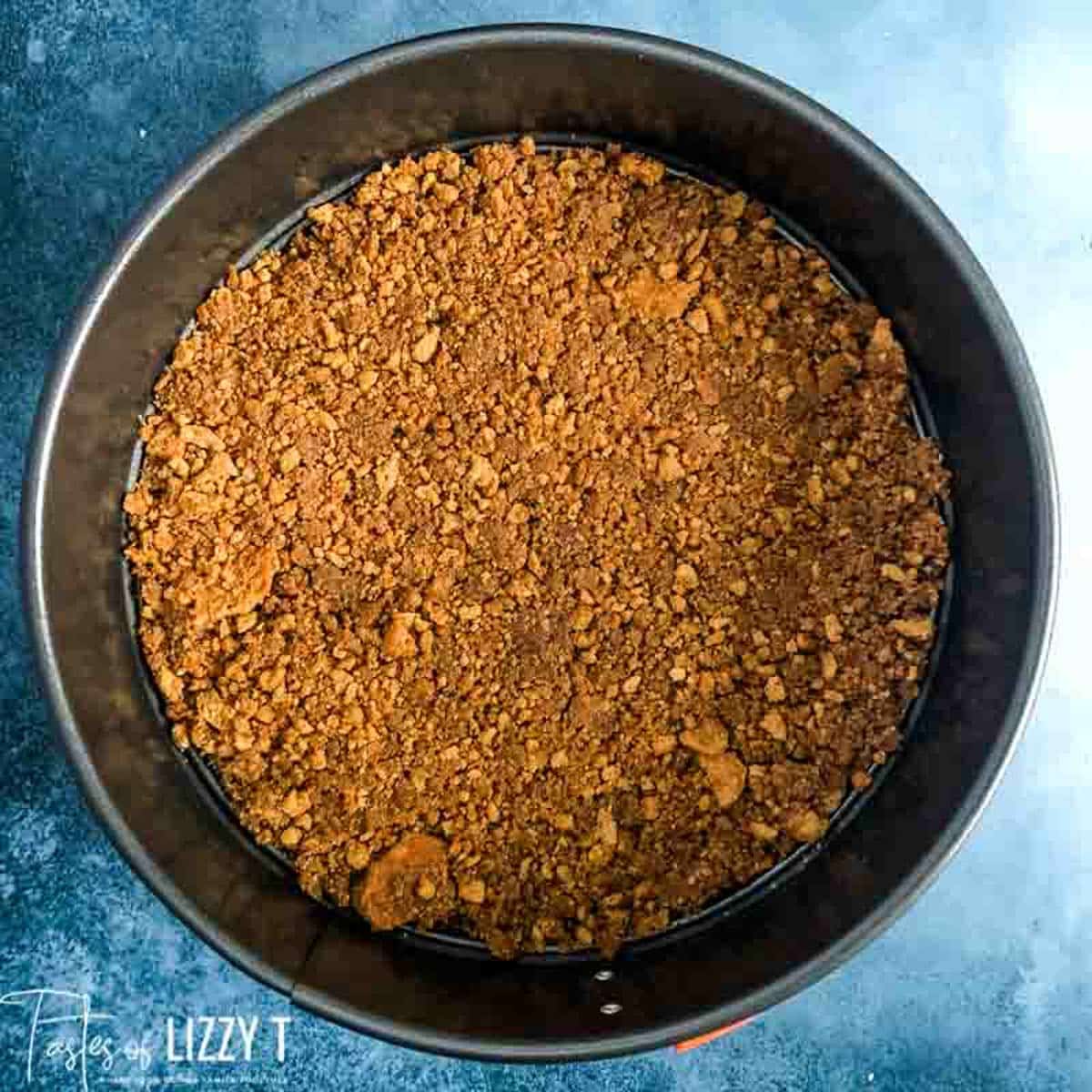 overhead view of a gingersnap crust in a springform pan