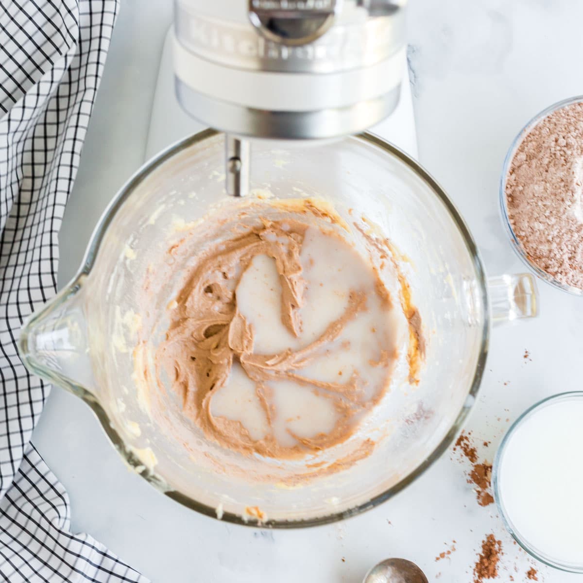 milk added to cake batter in a mixing bowl