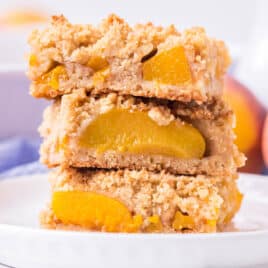 a stack of 3 peach bars with canned peaches