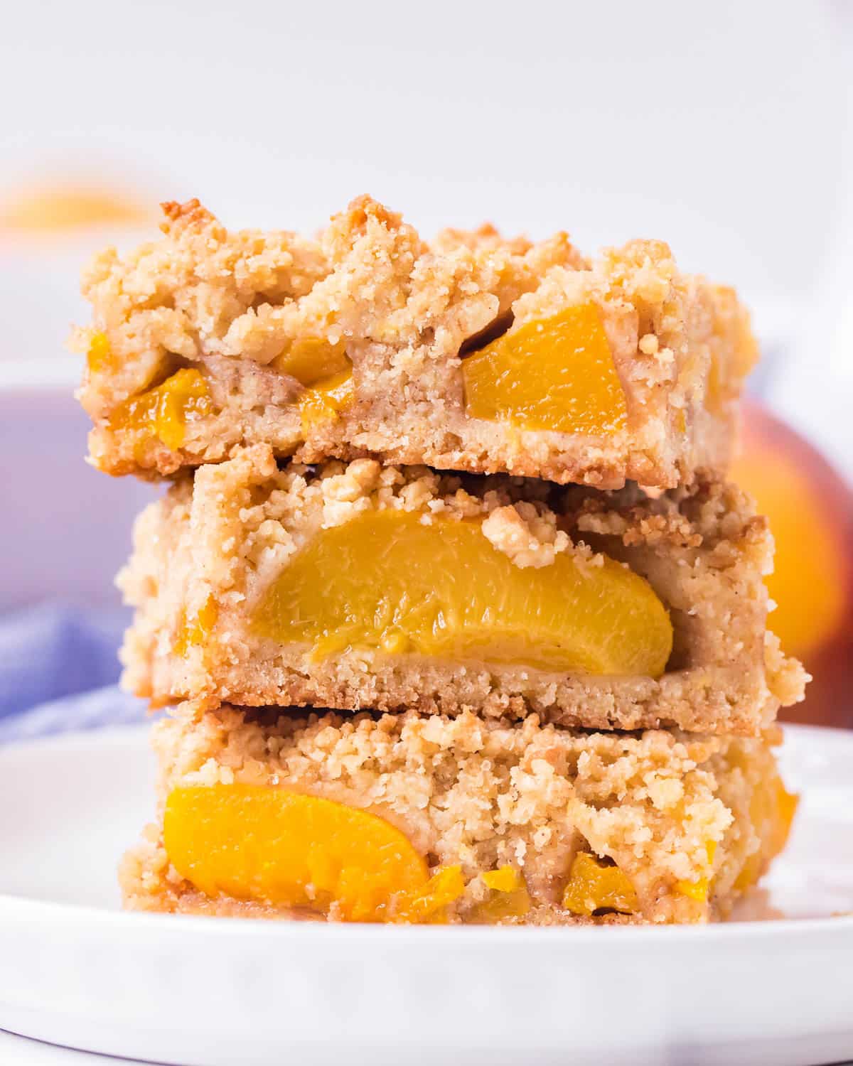 a stack of 3 peach bars with canned peaches