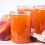 closeup of peach freezer jam in glass jars