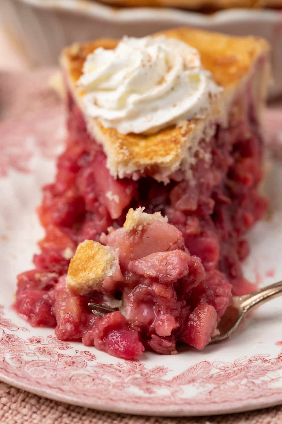 a piece of pear cranberry pie on a plate