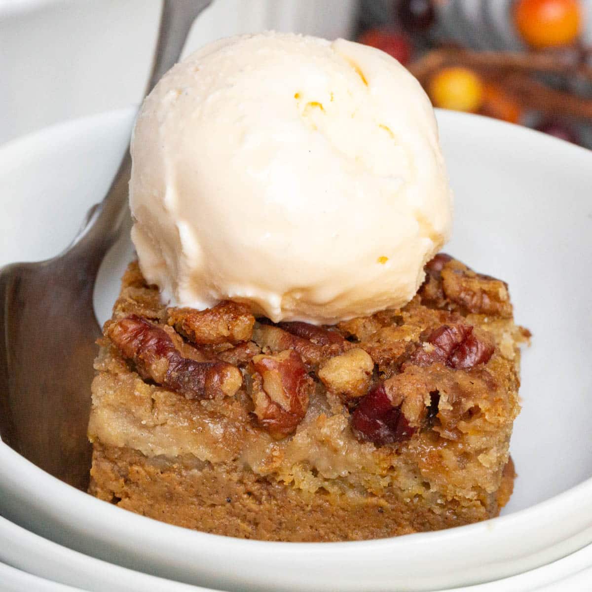 pumpkin dump cake with ice cream in a bowl