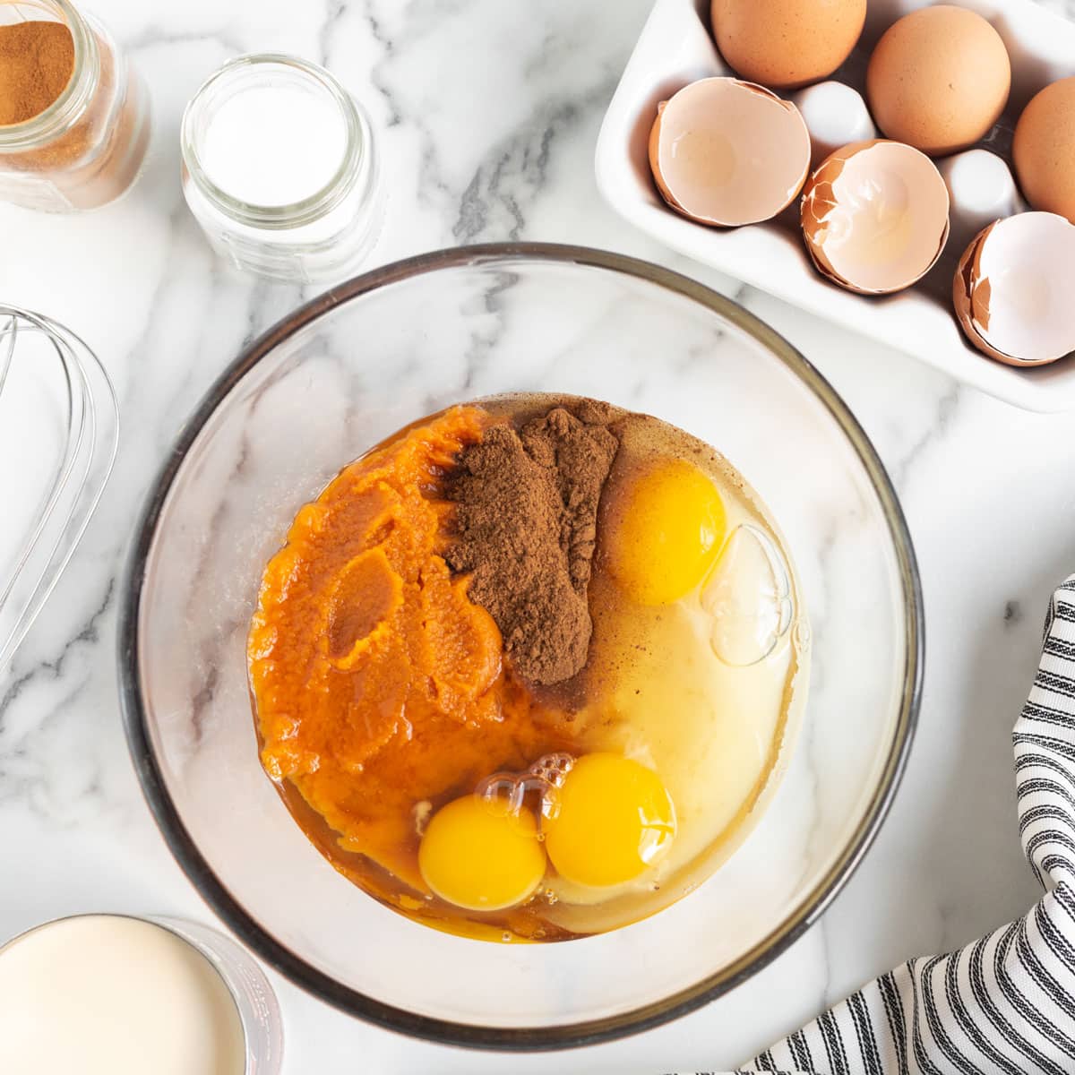 wet ingredients for pumpkin dump cake in a bowl