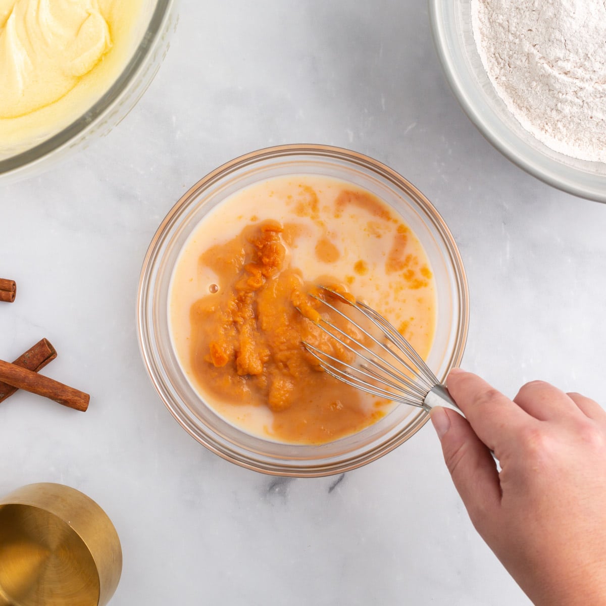 whisking pumpkin and milk in a bowl