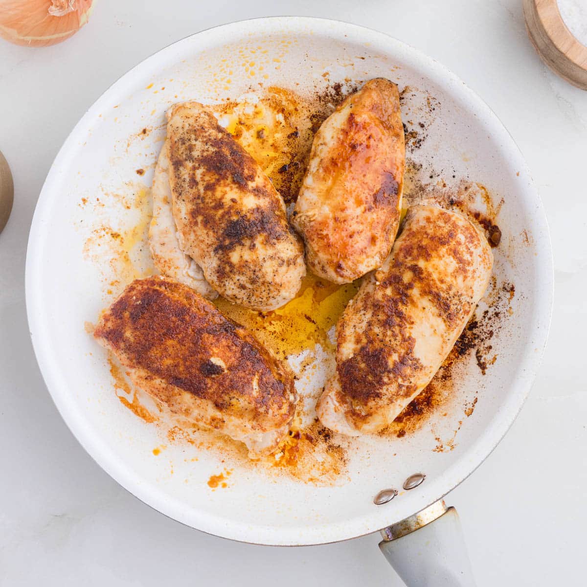 browned chicken in a skillet