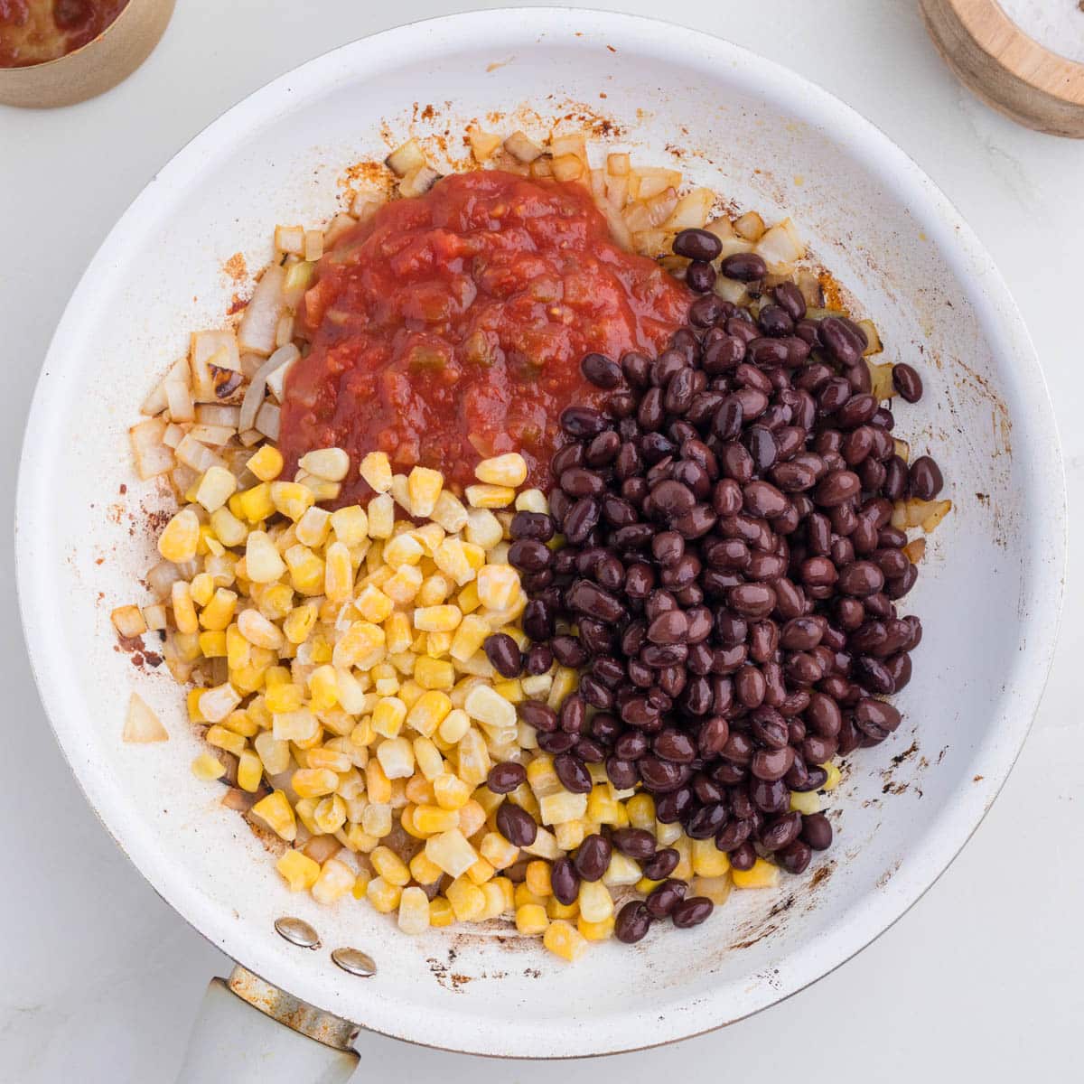 corn, beans, salsa and onions in a skillet