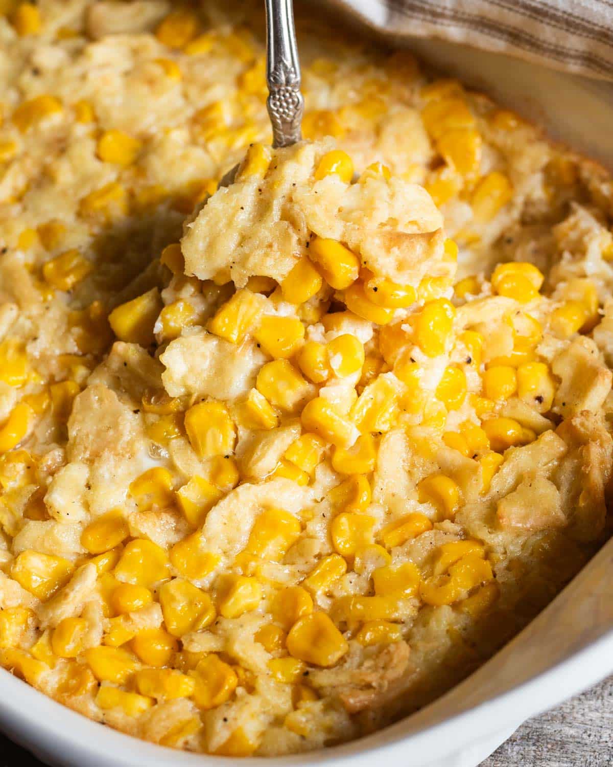 a spoon in scalloped corn casserole