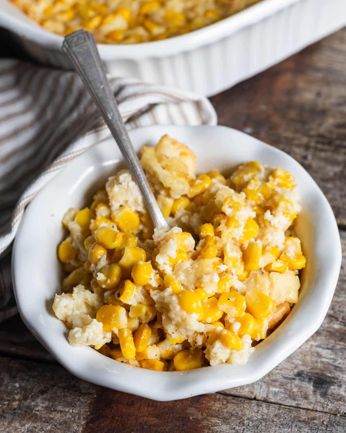 a bowl of scalloped corn with saltines