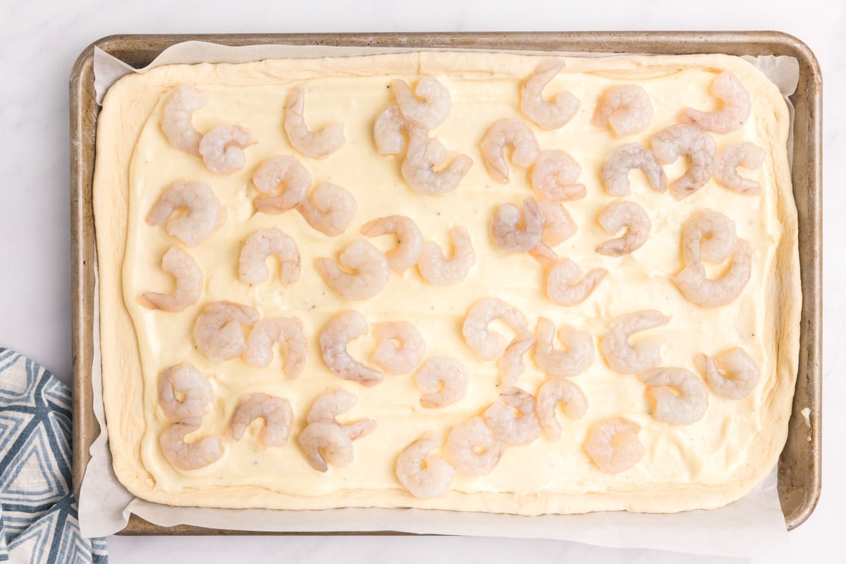 pizza dough with alfredo sauce and shrimp