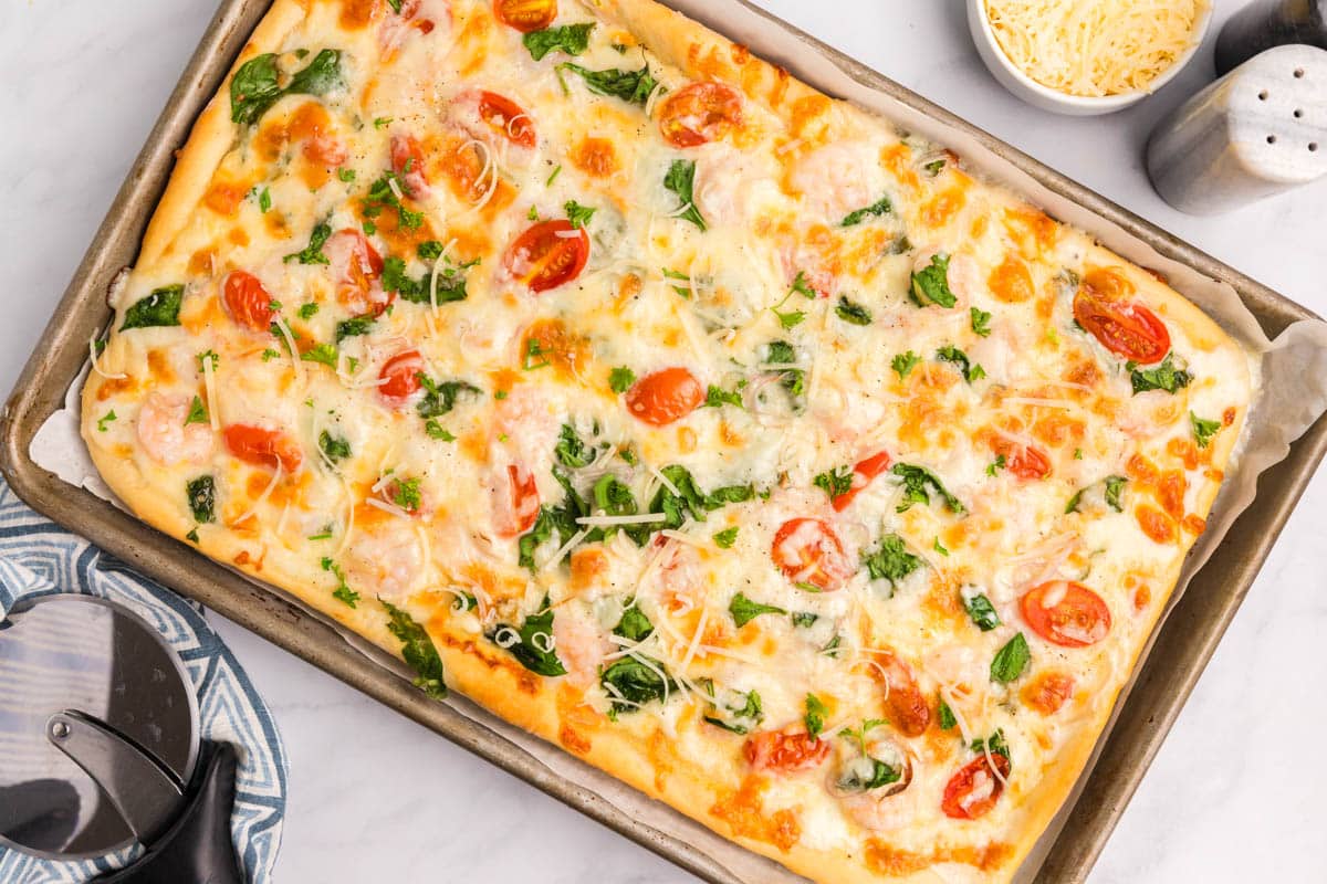 overhead view of baked alfredo shrimp pizza