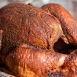 closeup of golden brown smoked turkey with rub