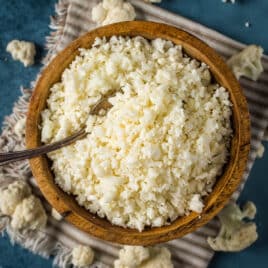 steamed cauliflower rice in a bowl with a spoon