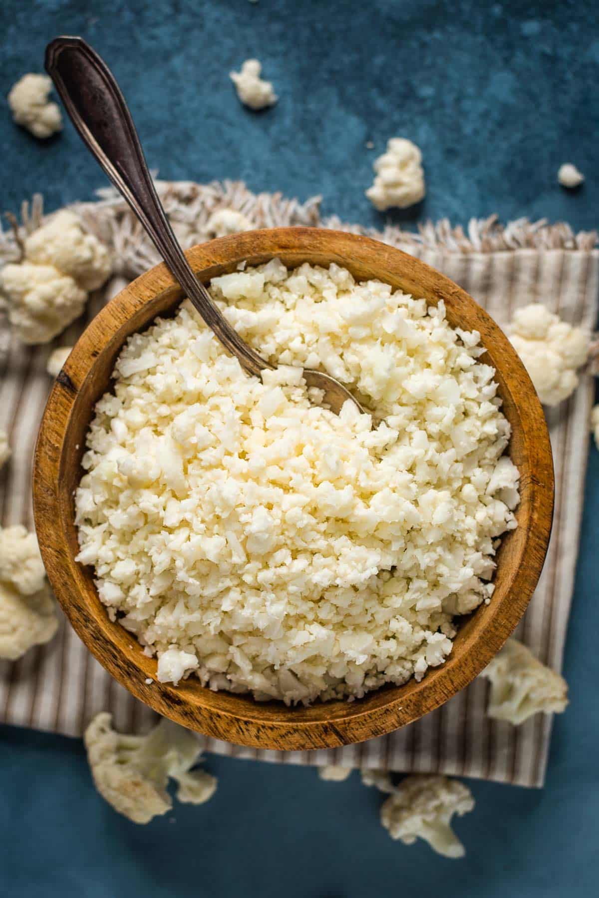 steamed cauliflower rice in a bowl with a spoon