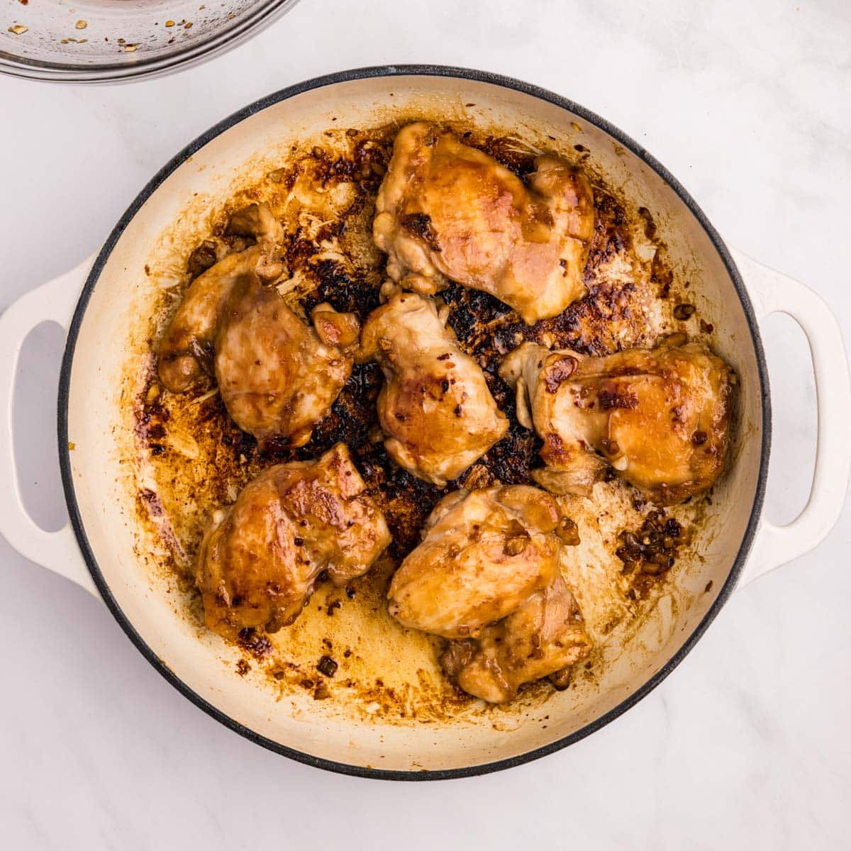 cooked chicken thighs in a skillet