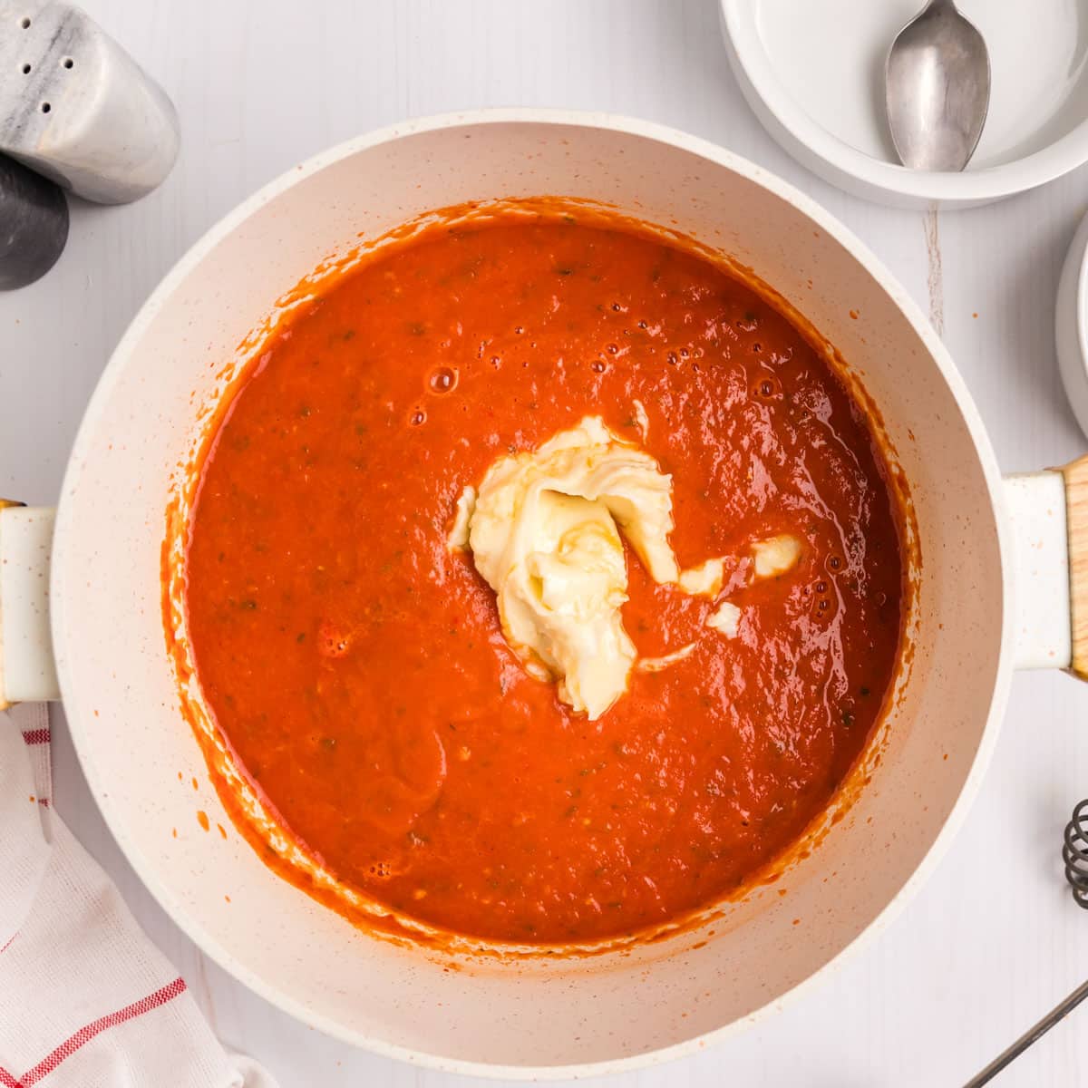 butter and cream roux in a saucepan of tomato soup