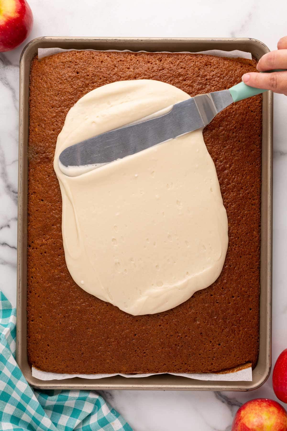 a spatula spreading icing on a cake