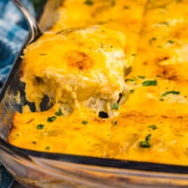 a spatula pulling out au gratin potatoes from a casserole