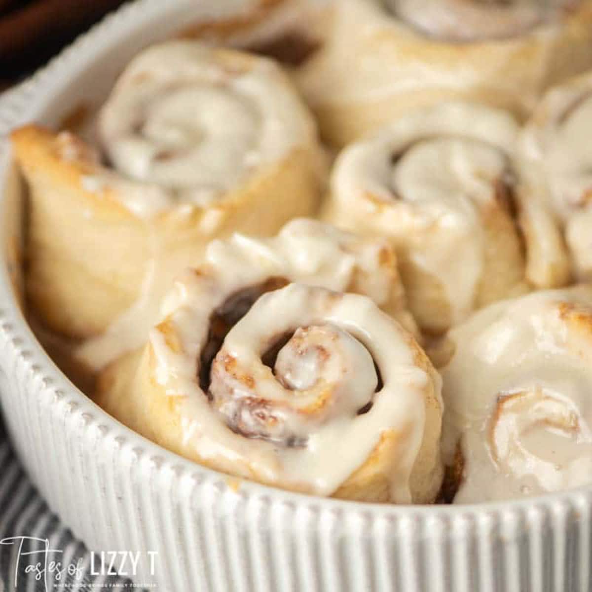 closeup of a pan of frosted cinnamon rolls