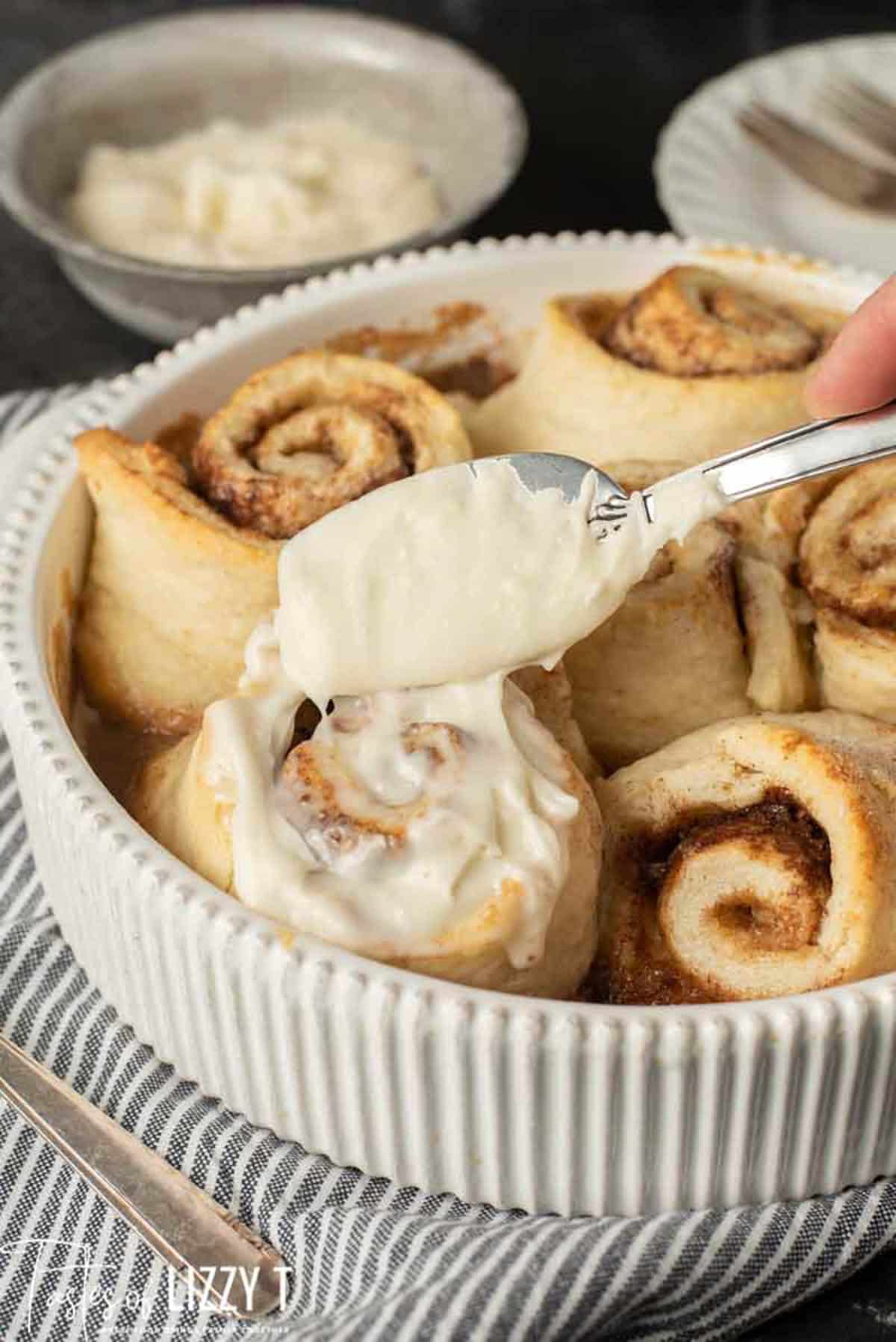 spreading frosting on a bisquick cinnamon roll