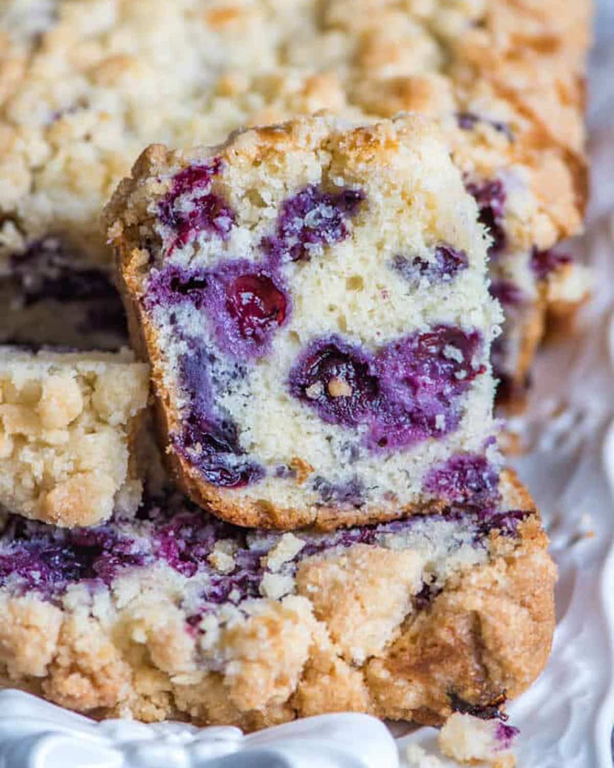 a slice of blueberry bread with crumble on top