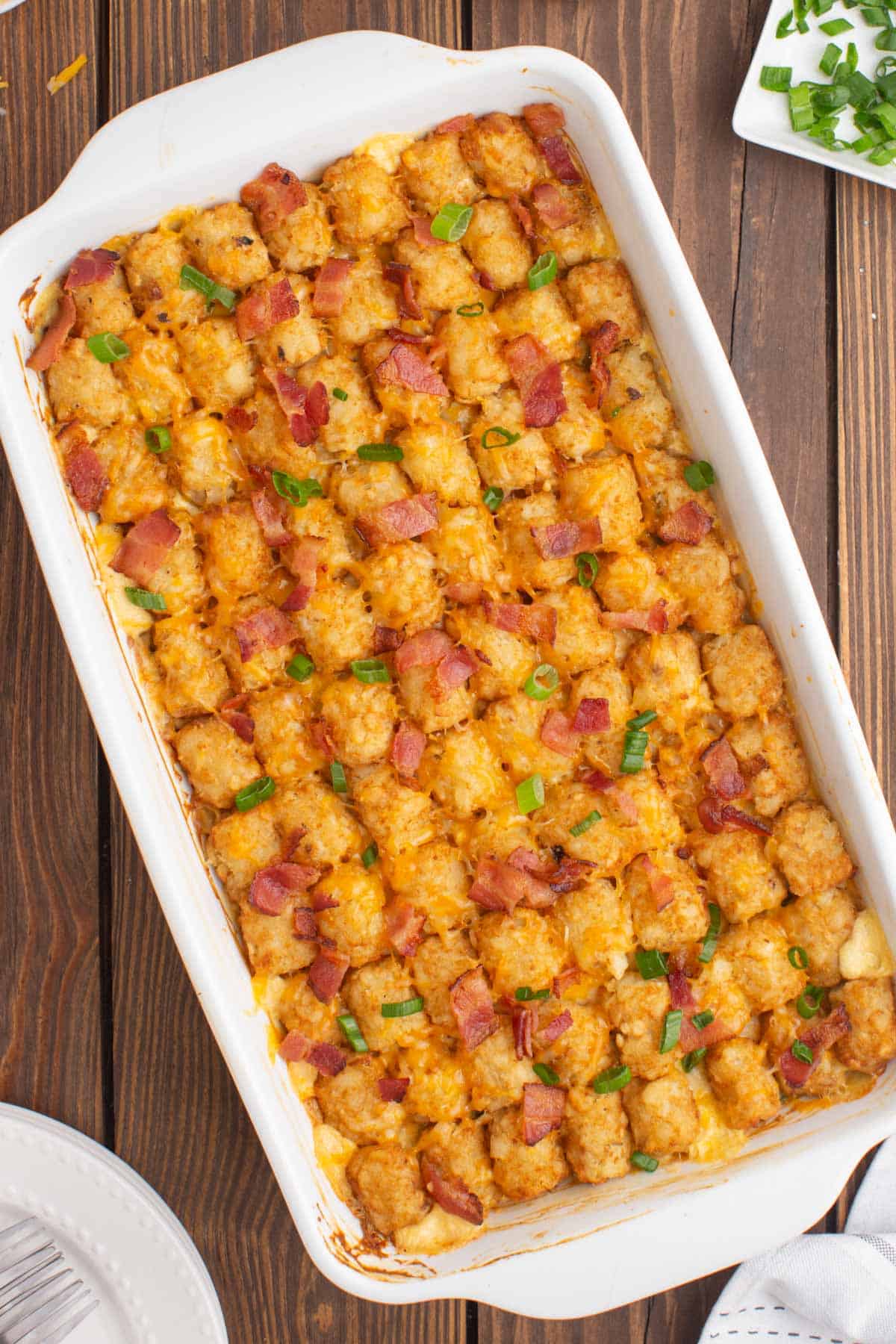 overhead view of tater tot casserole with chicken and bacon in a baking dish