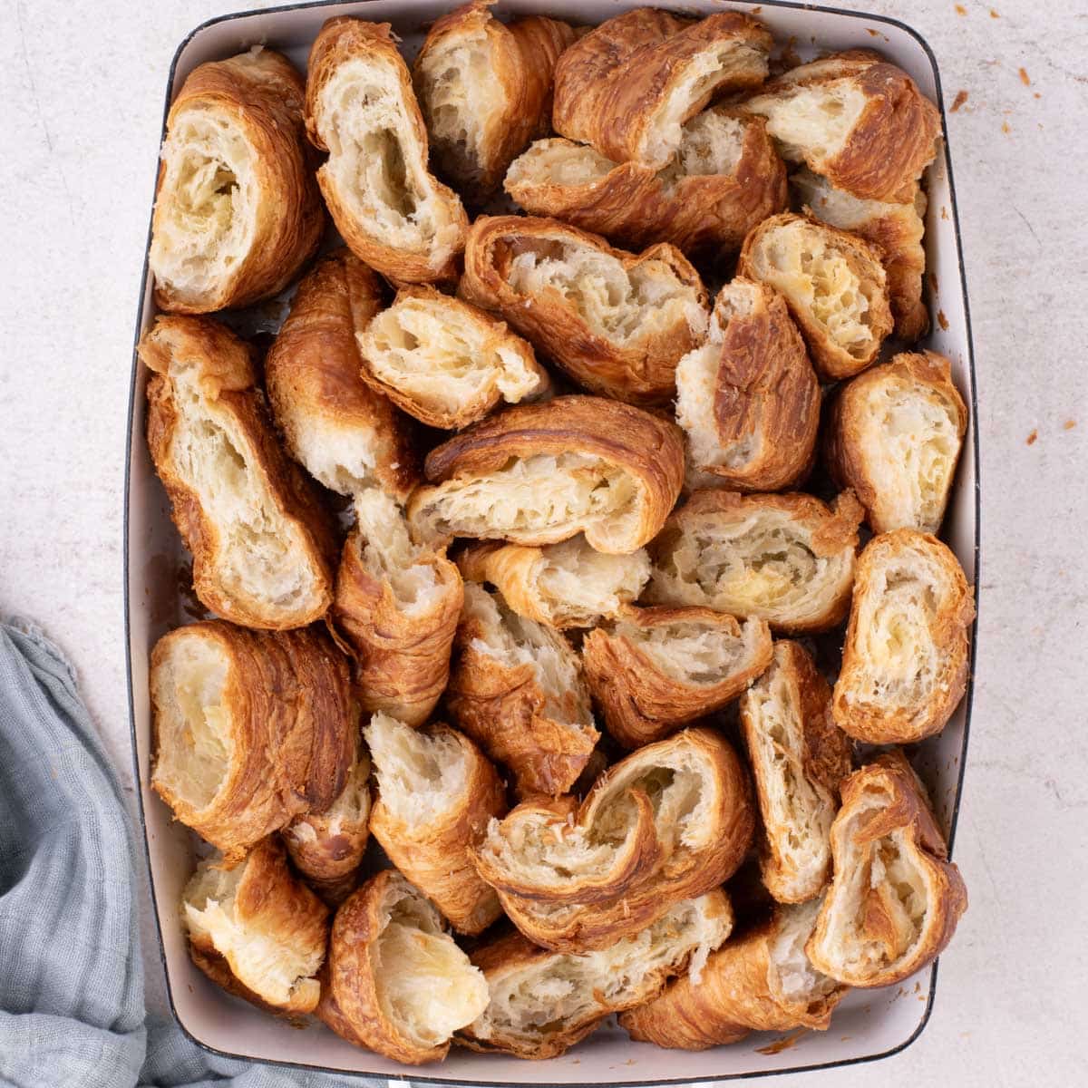 pieces of croissants in a baking dish