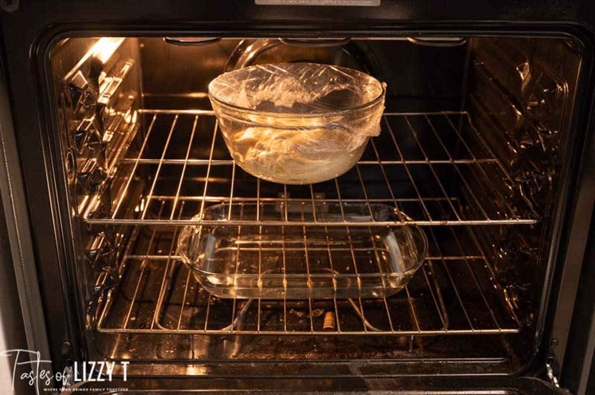 dough in an oven with a glass pan of water