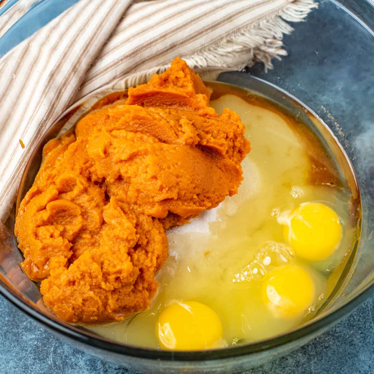 pumpkin, eggs, oil and sugar in a bowl, unmixed