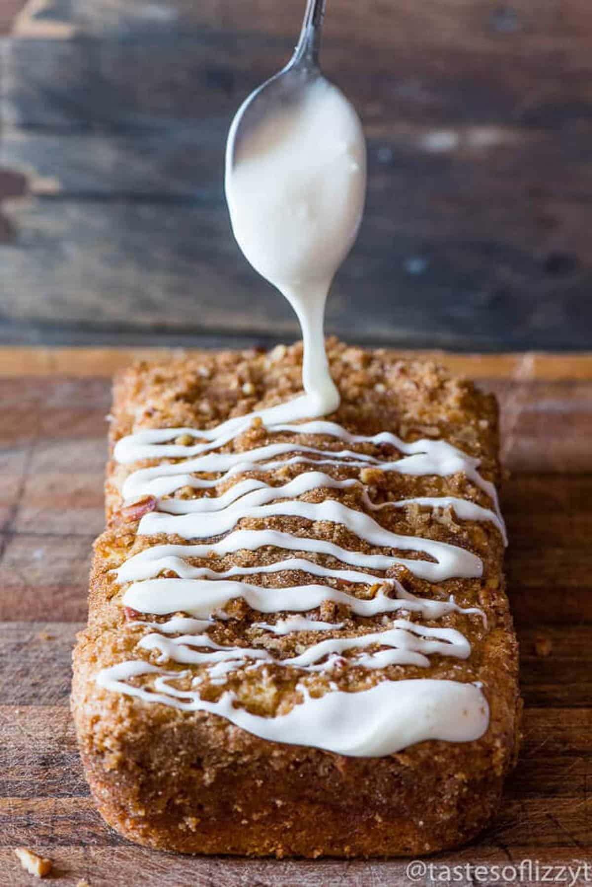 spoon drizzling glaze over quick bread