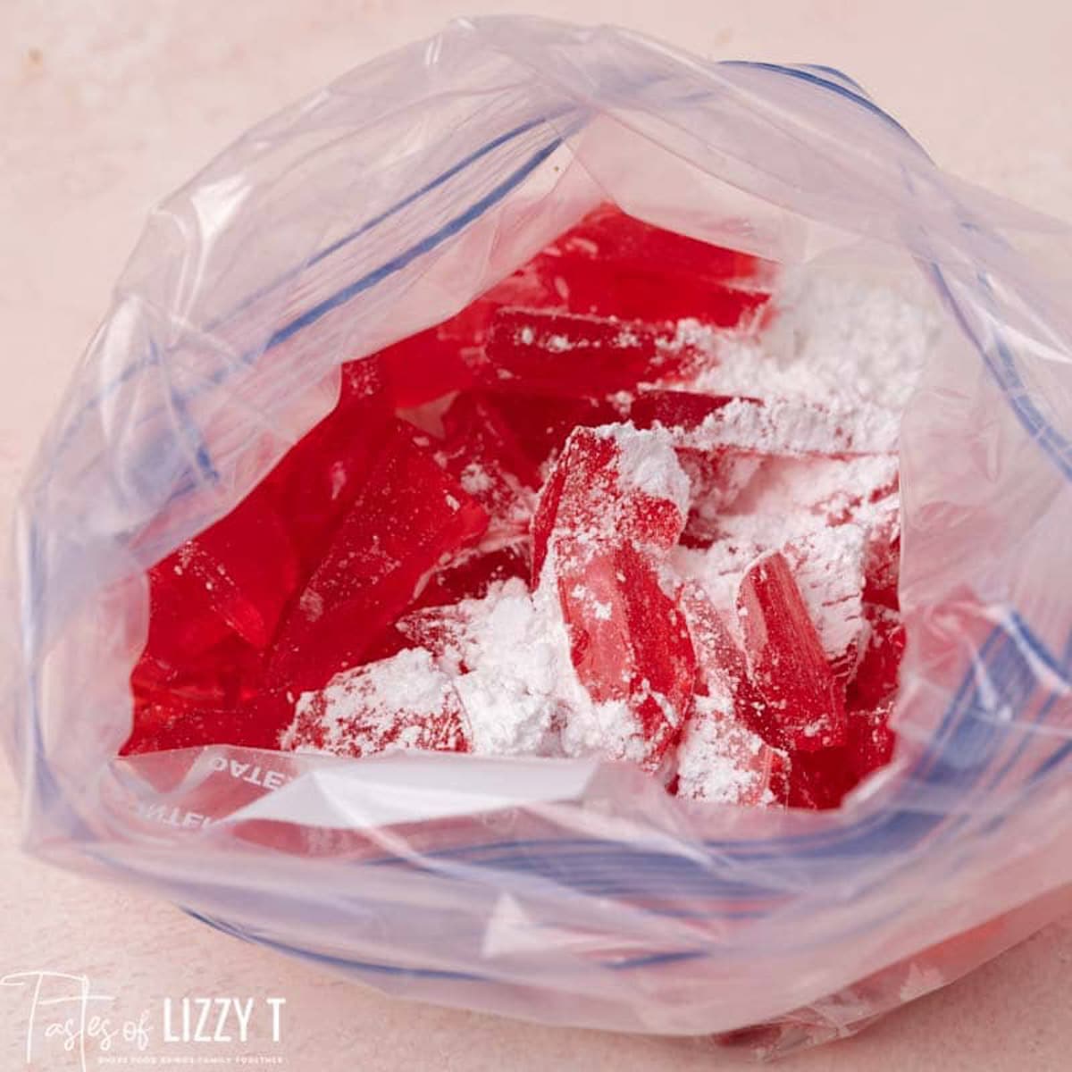 a bag with hard candy and powdered sugar shaken over it