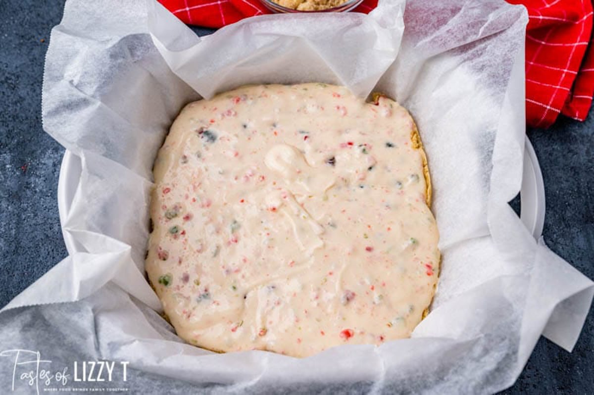 unbaked merry cherry cheesecake bars in a pan