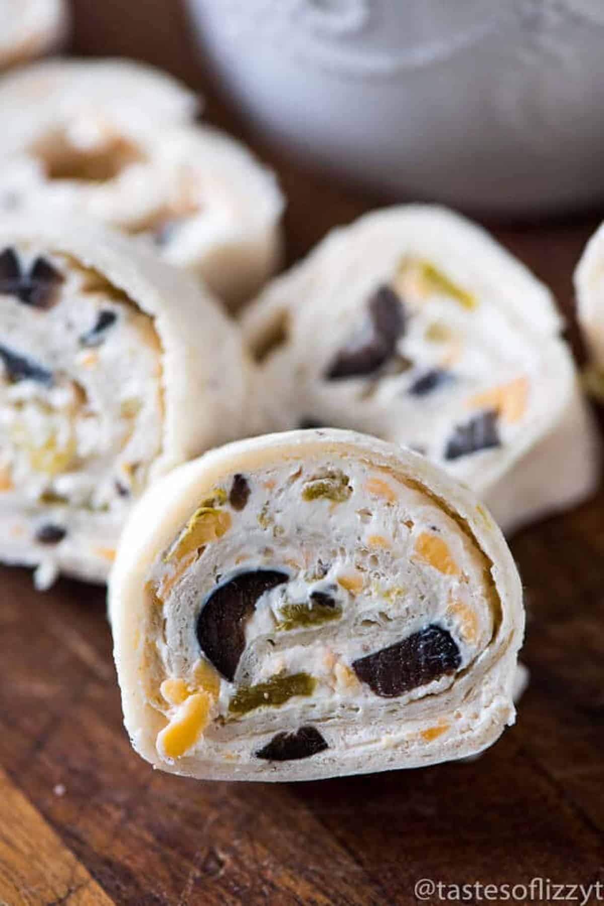 closeup of cream cheese tortilla rollups with olives