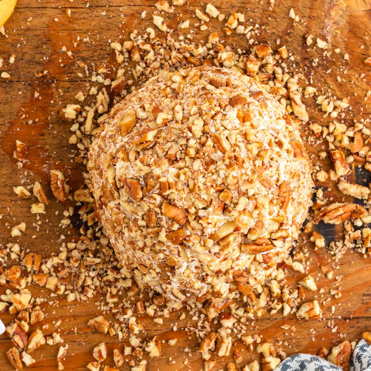 pineapple pecan cheese ball on a cutting board