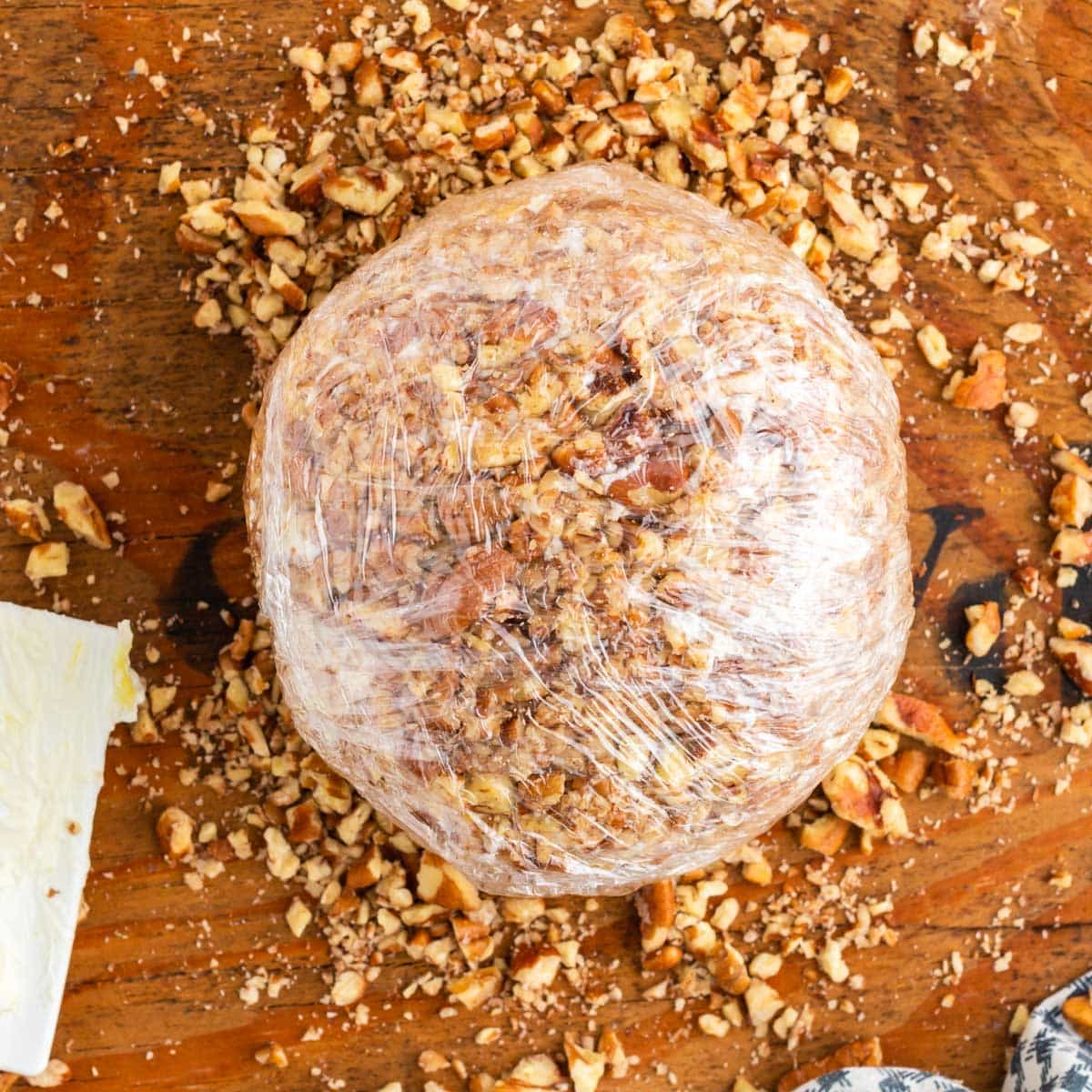 wrapped cheese ball on a cutting board