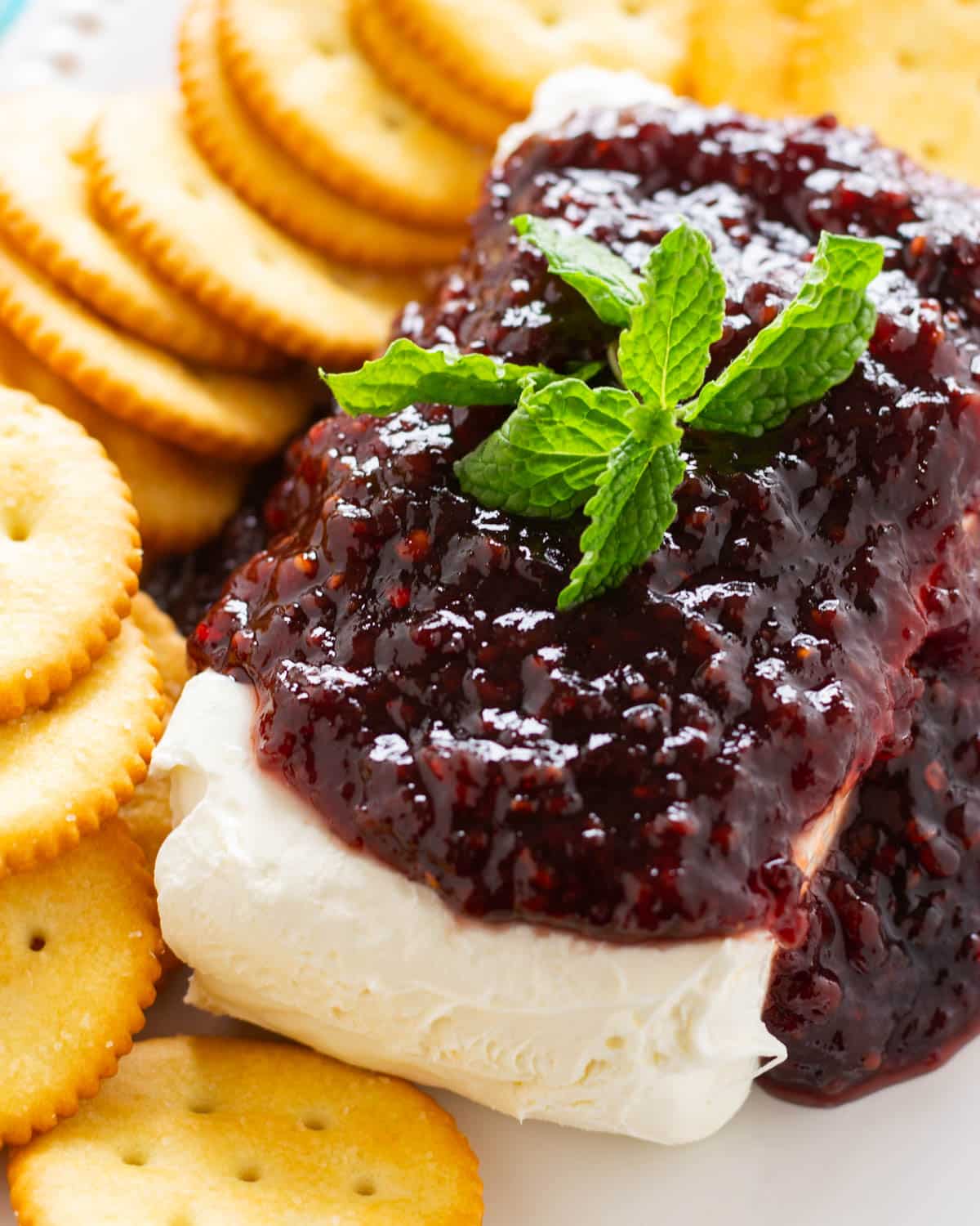 raspberry cream cheese dip on a plate with crackers