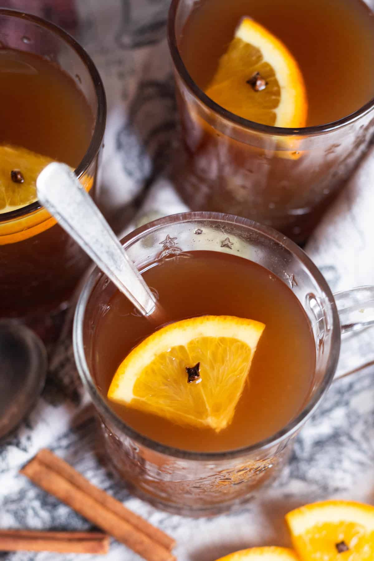 overhead view of cups of russian tea with slices of orange