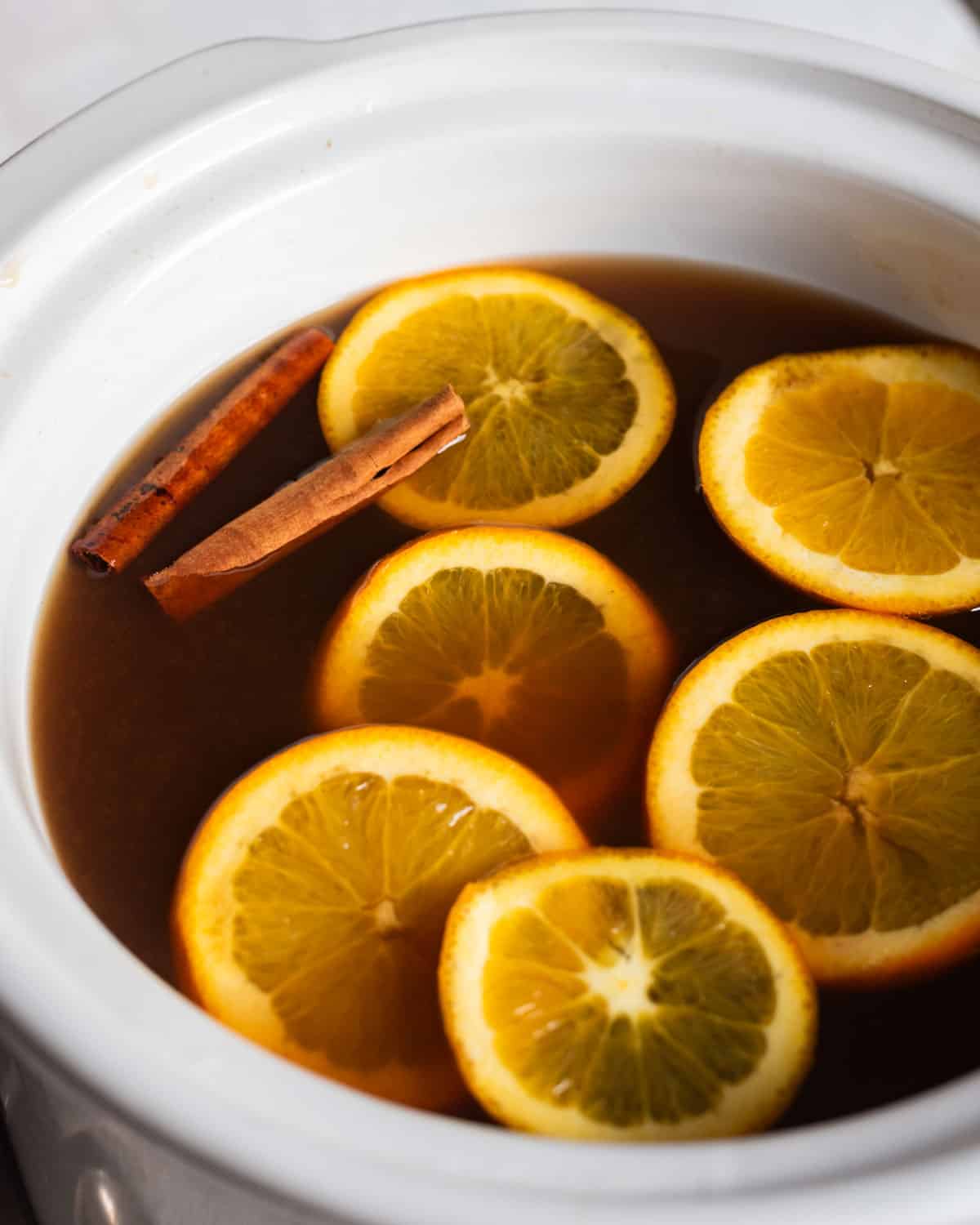 russian tea in a slow cooker with oranges and cinnamon