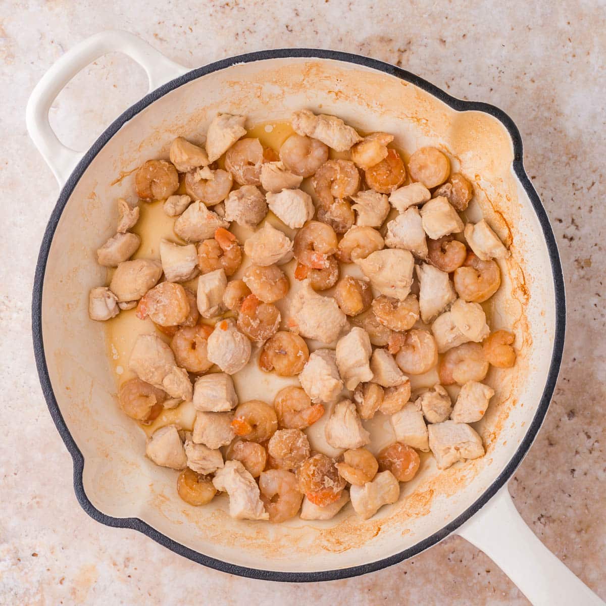 shrimp and chicken in a skillet