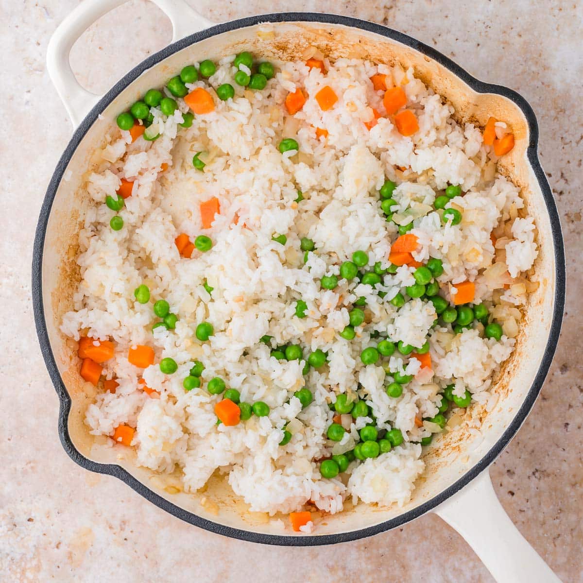 peas, carrots and rice in a skillet