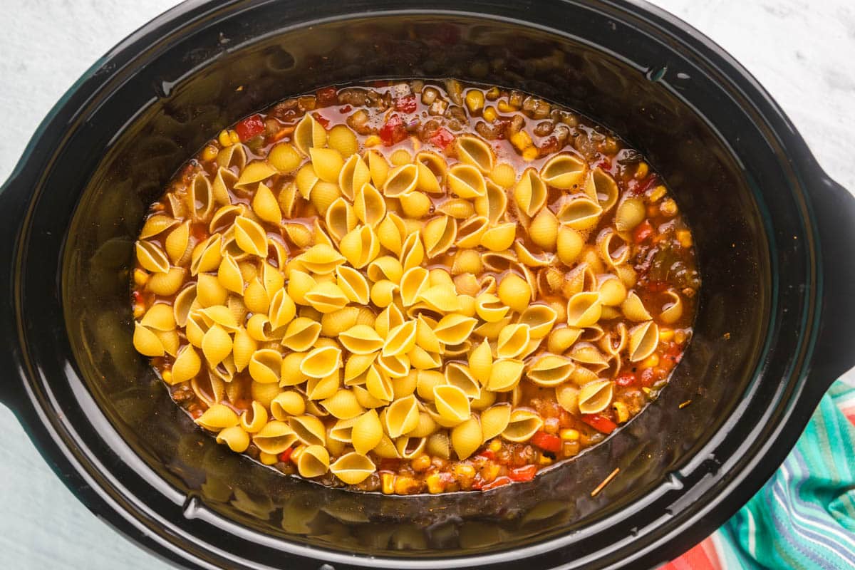 uncooked shell pasta in a slow cooker