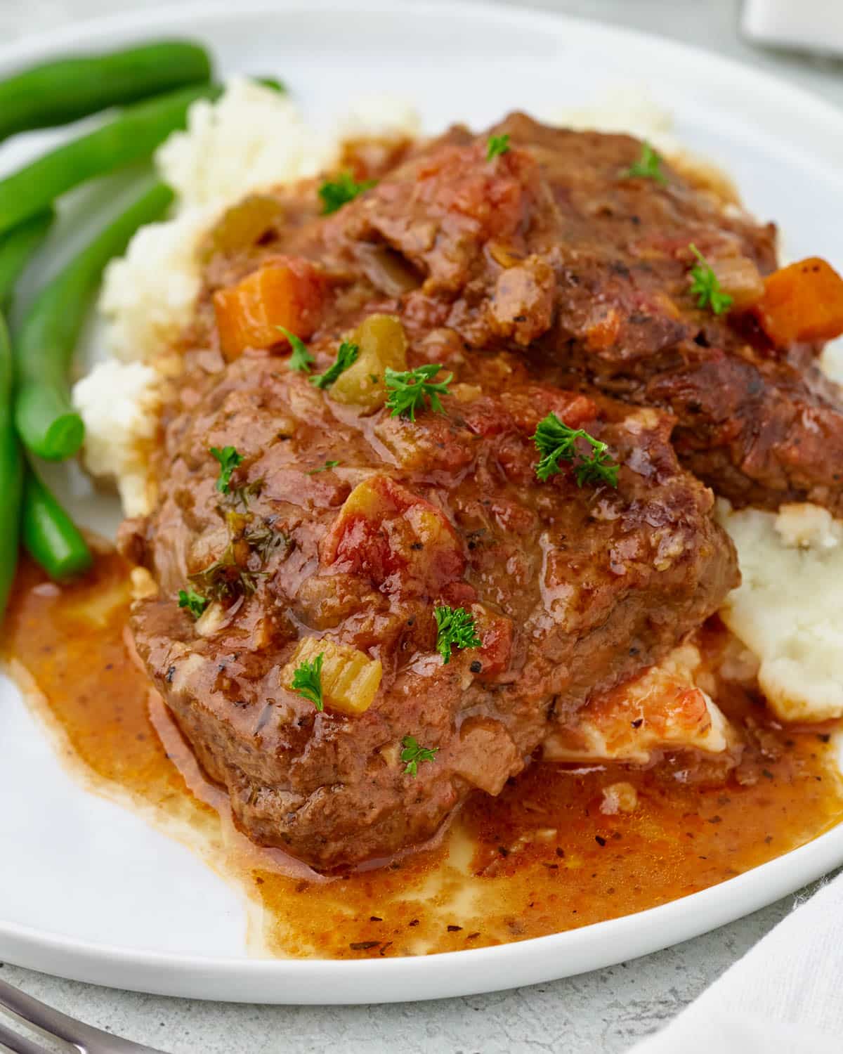 closeup of swiss steak with gravy on a plate