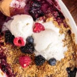 overhead view of berry crisp with ice cream on top