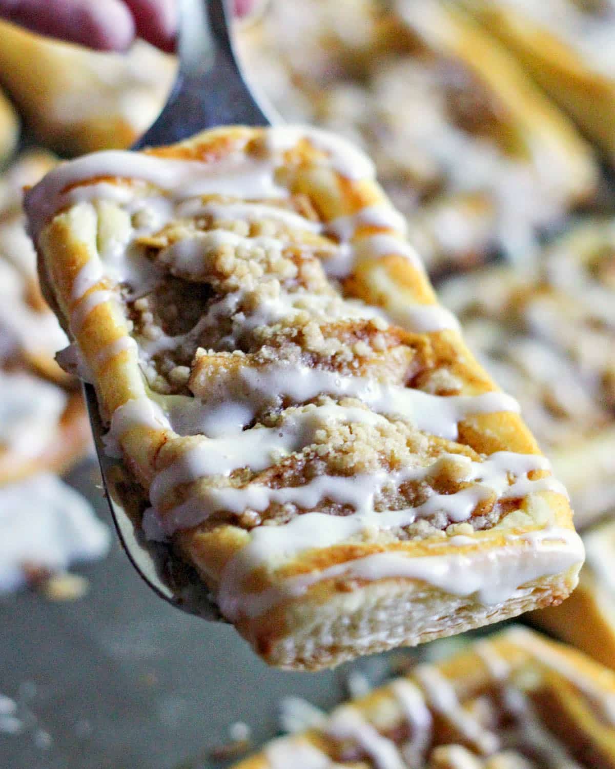 an apple crumble danish on a spatula