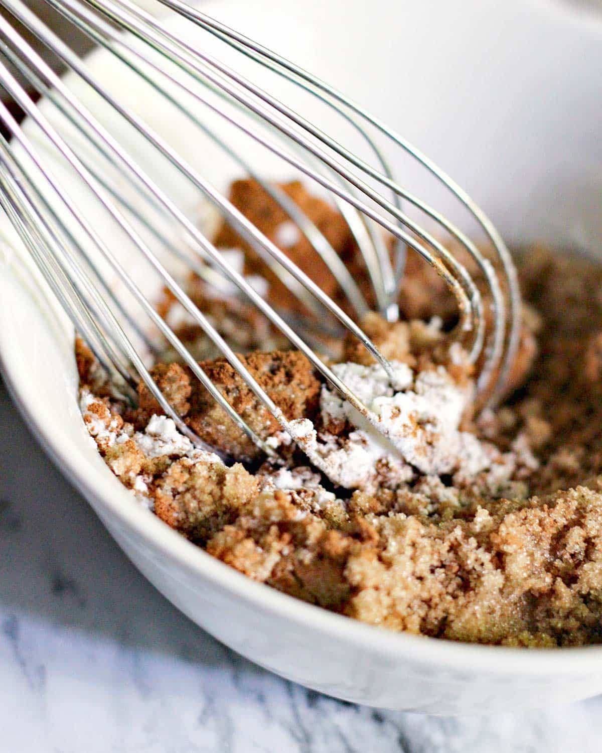 whisking brown sugar, cinnamon and flour in a bowl