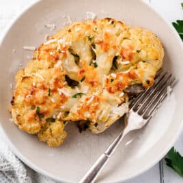 a baked cauliflower steak on a plate