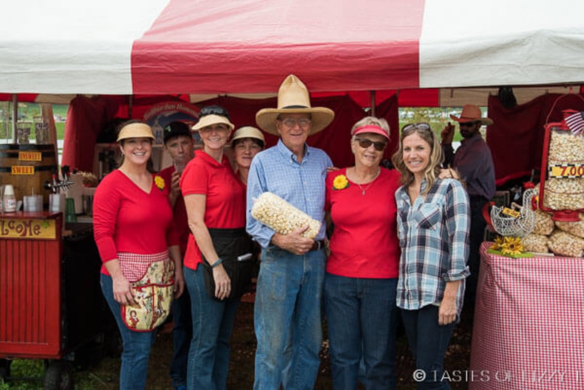 a group of people at a kettle corn stand